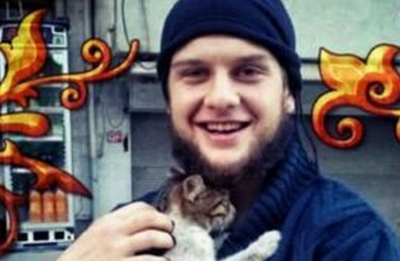 Twitter message included a picture of a man identified as Abu Hurayra holding a kitten, as well as pictures of the booby-trapped truck and an explosion. (photo credit: TWITTER)