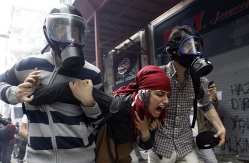 Plain clothes police officers detain a demonstrator during a protest in Istanbul May 31, 2014. (photo credit: REUTERS)