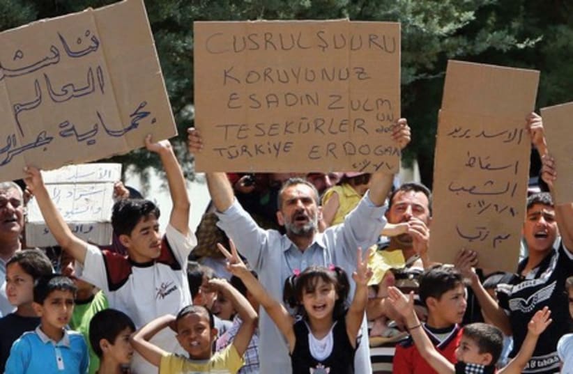 Syrians at a refugee camp in Turkey protest in 2011. (photo credit: REUTERS)