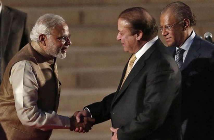 India's Prime Minister Narendra Modi (L) is greeted by his Pakistani counterpart Nawaz Sharif after Modi took the oath of office at the presidential palace in New Delhi May 26, 2014 (photo credit: REUTERS)