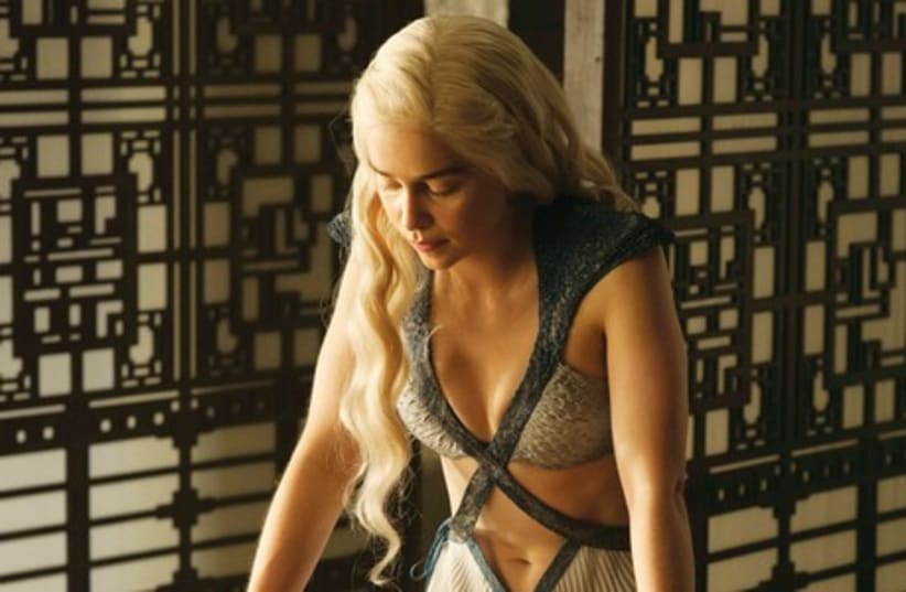 DAENERYS TARGARYEN, played by Emilia Clarke, surveys a map of the kingdom of which she is on a quest to reclaim her right as heir to the throne. (photo credit: HELEN SLOAN/HBO)