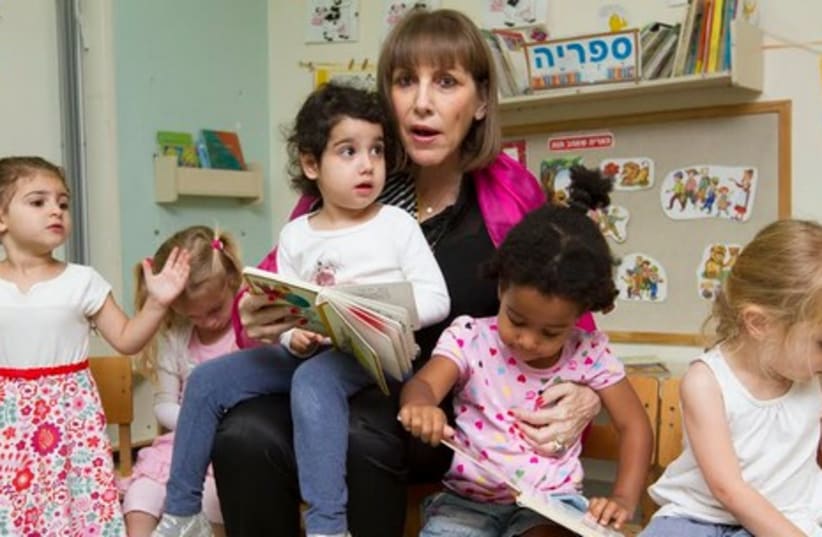 Livnat with children at daycare. (photo credit: ELI DASSA)