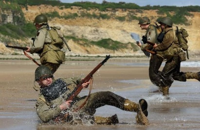 Re-enactment of a D-Day landing on Omaha Beach in Vierville-sur-Mer, on the Normandy coast. (photo credit: REUTERS)