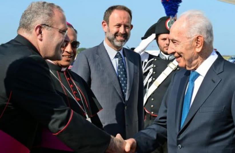 President Shimon Peres is greeted after arrival in Rome. (photo credit: HAIM TZACH/GPO)