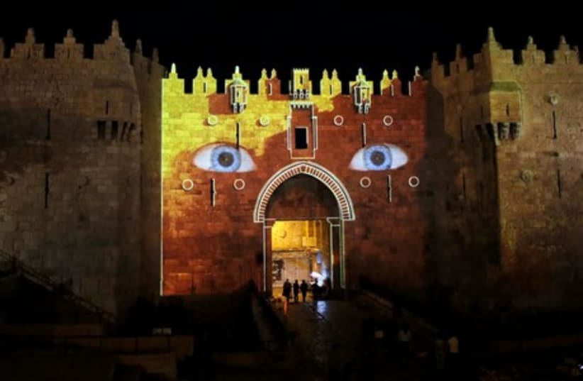 Damascus Gate, which leads to Jerusalem’s Old City, is projected with blue eyes to promote the capital’s 6th annual International Festival of Light, June 10, 2014. (photo credit: REUTERS)