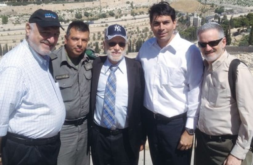 DEPUTY DEFENSE Minister Danny Danon (second from right), stands with Mount of Olives activists (from left) Harvey Schwartz, Police Commander Avraham Saar, Abe Lubinsky and Jeff Daube on the Mount of Olives yesterday. (photo credit: DANIEL K. EISENBUD)
