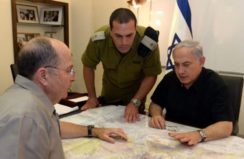 Prime Minister Binyamin Netanyahu (R), an IDF officer, and Defense Minister Moshe Ya'alon at the Kiryat Defense Ministry Compound in Tel Aviv. (photo credit: GPO)