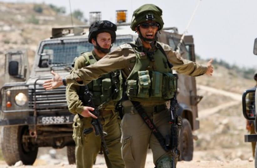 Israeli soldiers patrol the West Bank City of Hebron June 13, 2014 (photo credit: REUTERS)