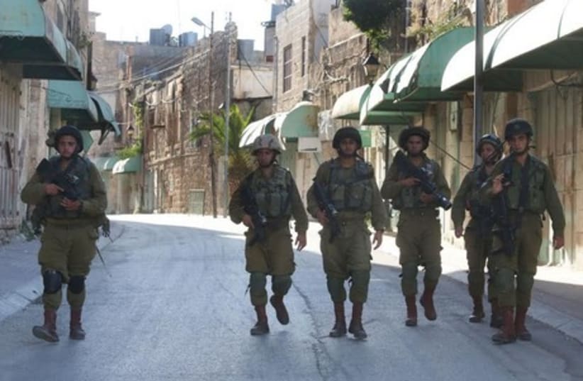 IDF soldier in Hebron, June 15, 2014.  (photo credit: MARC ISRAEL SELLEM/THE JERUSALEM POST)