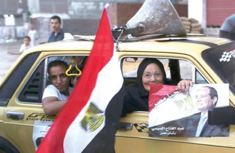 Abd al-Fattah al-Sisi supporters on their way to vote, Cairo, May 28 (photo credit: REUTERS/ASMAA WAGUIH)