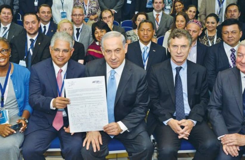 Participants in the 19th annual International Conference of Mayors, taking place this week in Israel, present Prime Minister Binyamin Netanyahu with an open letter yesterday calling for the return of the three kidnapped yeshiva students.  (photo credit: PRIME MINISTER'S OFFICE)