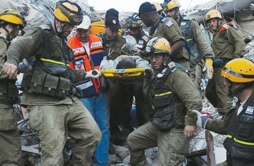 IDF Personnel treat a victim of the earthquake in Haiti in 2010. (photo credit: IDF SPOKESMAN'S OFFICE)