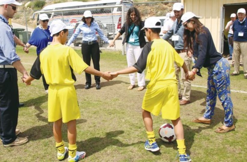 Boys participate in Value Sports with JDC Board members on the Beitar field in Jerusalem. (photo credit: SASSON TIRAM)