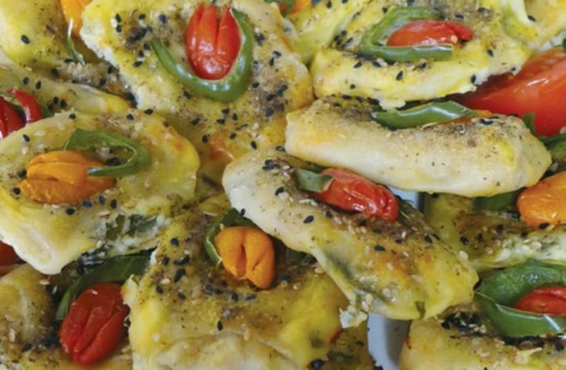 Sweet, red and orange mini-peppers are pressed into cheese boreks. (photo credit: YAKIR LEVY)