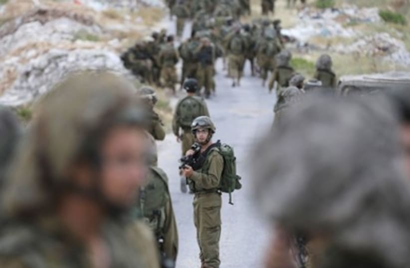 IDF soldiers from the Paratroopers Brigade search for the missing teens near Hebron. (photo credit: REUTERS)