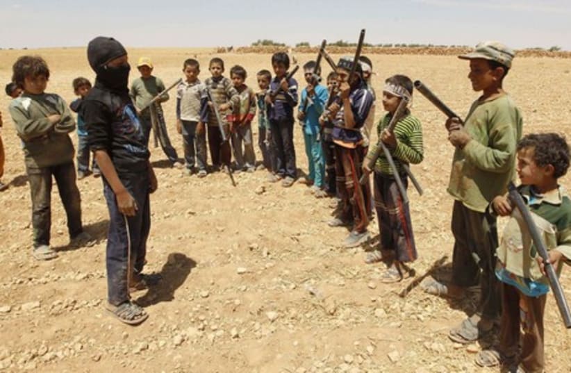 Boys attend a "military-styled" training in the syrian countryside (photo credit: REUTERS)