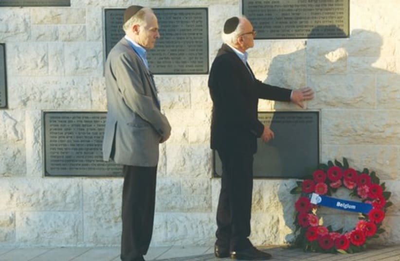 Eli Ringer (left), of the Flemish Forum of Jewish Organizations, and Baron Julien Klener, president of the Consistoire Central Israèlite de Belgique, honor the memory of those killed at the Jewish Museum shooting in Brussels during a ceremony on Mount Herzl. (photo credit: MARC ISRAEL SELLEM/THE JERUSALEM POST)
