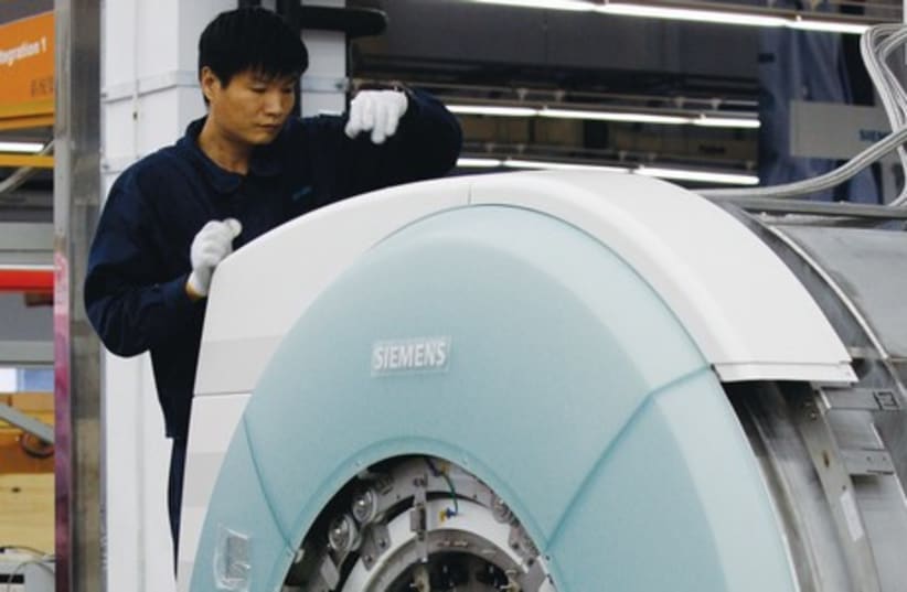 An MRI machine being assembled (photo credit: REUTERS)