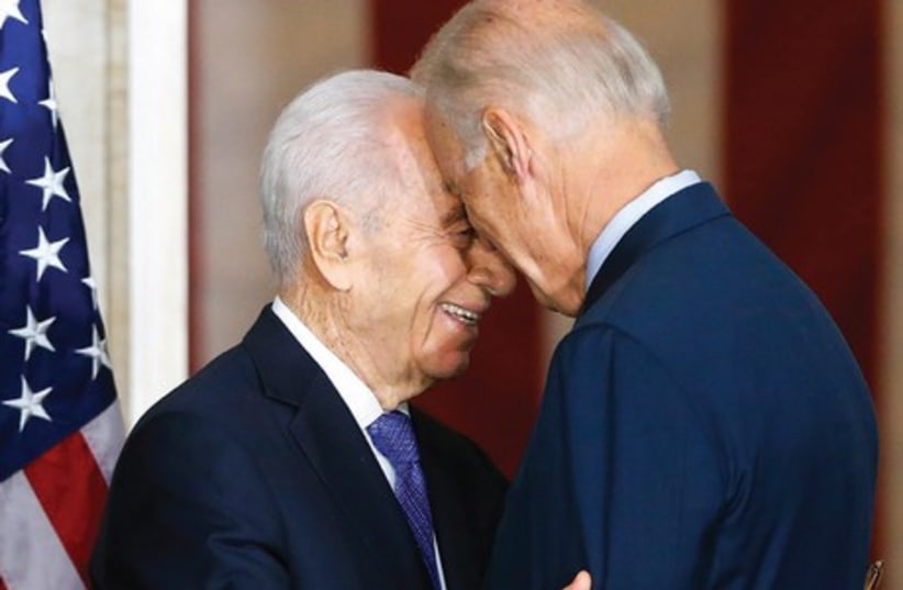 PRESIDENT SHIMON PERES embraces US Vice President Joe Biden after  receiving the Congressional Gold Medal in Washington yesterday. (photo credit: REUTERS)