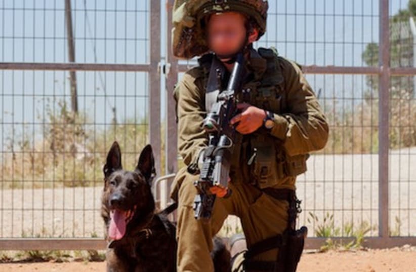 An IDF soldier in the elite Oketz unit with his dog. (photo credit: IDF)