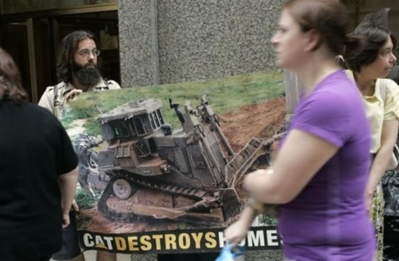 Protesters gather outside the Caterpillar annual shareholder meeting in Chicago to demonstrate against how Israel acquires Caterpillar heavy machinery from the US. (photo credit: REUTERS)