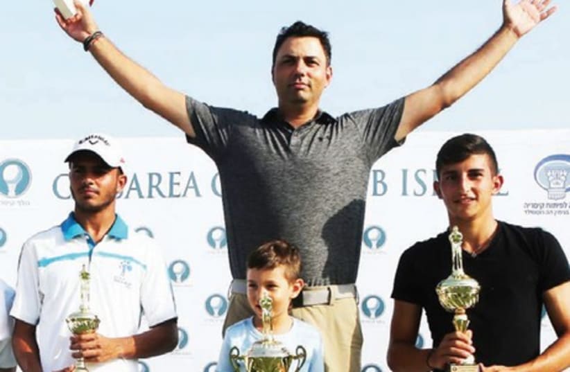 Men’s Open gross-score winners at the Caesarea Club Championship – first-place Roie Edelman and his son (center), second-pace Eitan Solomon (right) and third-place Dolev Gueta (left) pose with their trophies after the tournament (photo credit: Courtesy)
