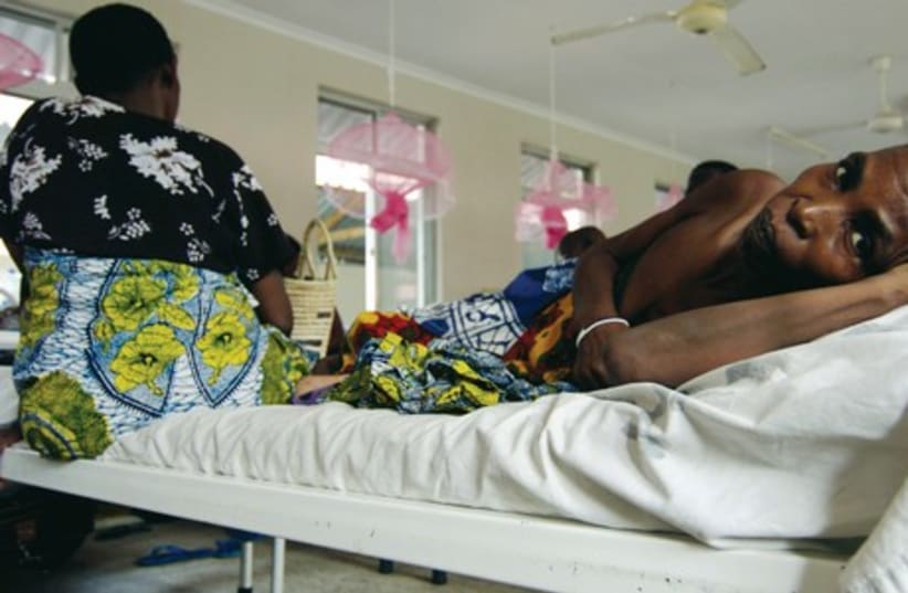Cancer patients share a bed in the female ward of Tanzania’s cancer institute in the capital Dar es Salaam in this photo from November 11, 2009. Many women worldwide who are diagnosed with cervical cancer live in the developing world and a high percentage in Africa (photo credit: REUTERS)