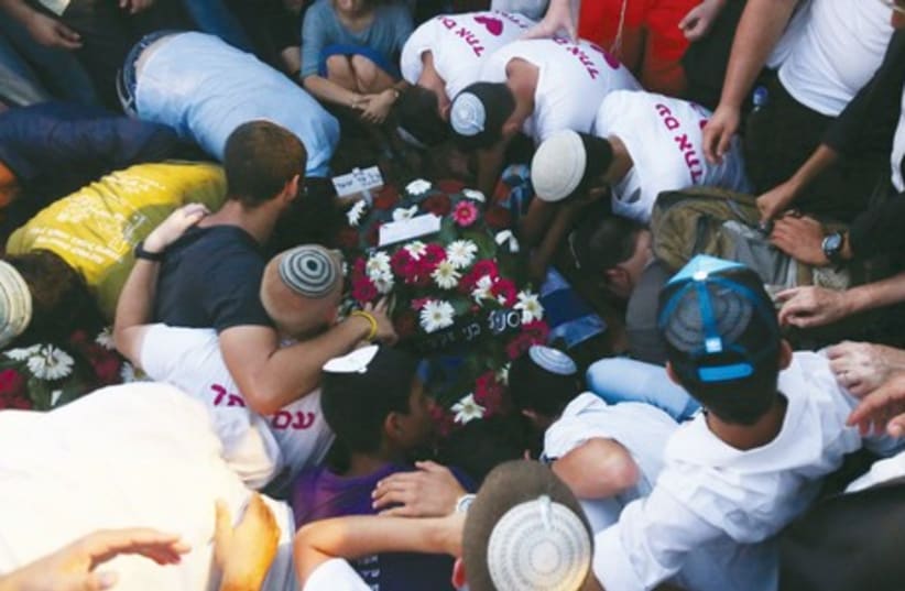 Mourners gather at the grave of Gil-Ad Shaer on Tuesday. (photo credit: MARC ISRAEL SELLEM/THE JERUSALEM POST)