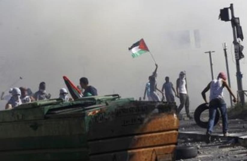 Palestinian stone-throwers clash with Israeli police in Shuafat. (photo credit: REUTERS)