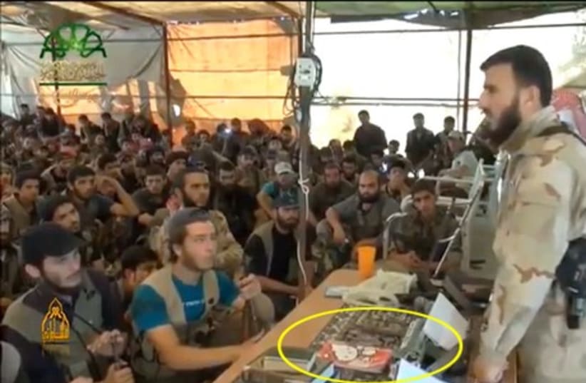 Sheikh Zahran Alloush with the Hello Kitty notebook by his side. (photo credit: YOUTUBE SCREENSHOT)