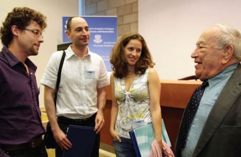 MARCEL ADAMS (right) meets with doctoral students, each of whom will receive one of his annual fellowships.  (photo credit: ISRAEL ACADEMY OF SCIENCES AND THE ARTS)