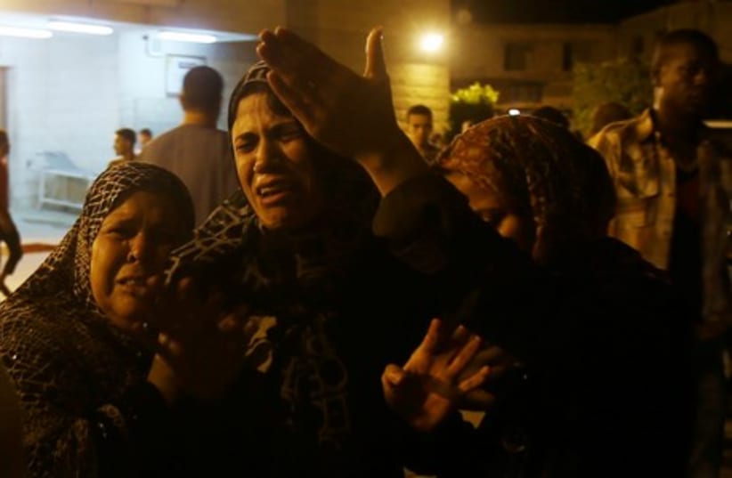 Women mourn after an Israeli air strike killed two Palestinian militants, at a hospital morgue in the central Gaza Strip July 6, 2014. (photo credit: REUTERS)