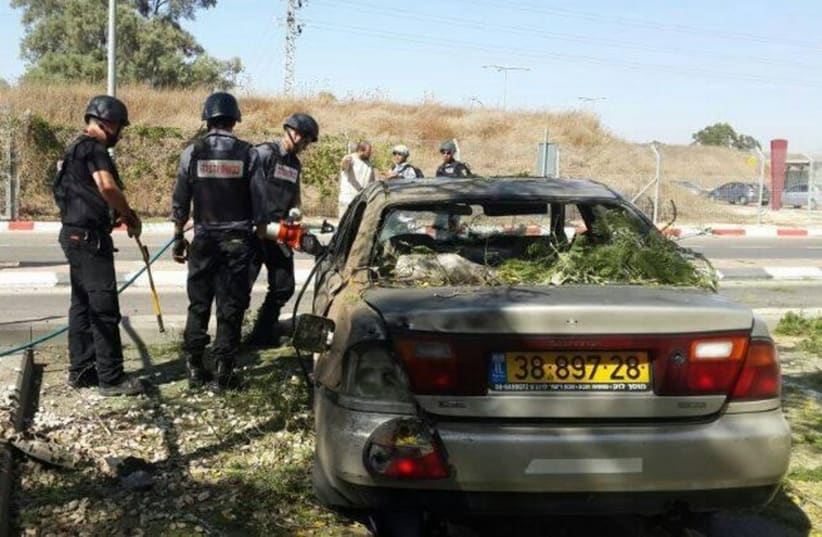 A parked car hit by a rocket in the Sha'ar Hanegev Regional Council. (photo credit: ISRAEL POLICE)