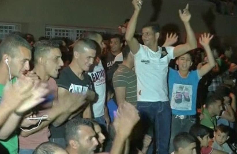 Palestinians in Hebron cheer as Gaza rockets fly toward Israeli population centers. (photo credit: screenshot)