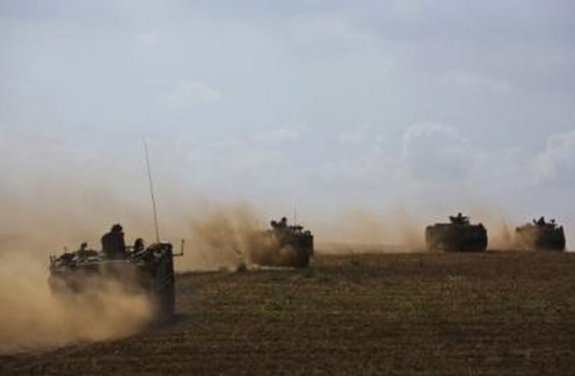 IDF armored personnel carriers (APCs) drive outside the Gaza Strip. (photo credit: REUTERS)