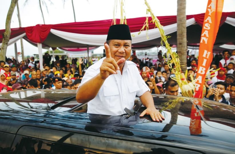 Indonesia's presidental candidate Prabowo Subianto gestures as he leaves a campaign rally in Ciparay near Bandung, West Java, on July 3. (photo credit: REUTERS)