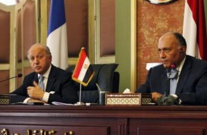 French Foreign Minister, Laurent Fabius (L), talks during a news conference with his Egyptian counterpart Samih Shukri (R), in Cairo July 18, 2014. (photo credit: REUTERS)