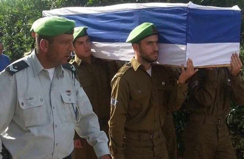 Nahal Brigade soldiers carry Sgt. Eitan Barak, 20, to his resting place. (photo credit: BEN HARTMAN)