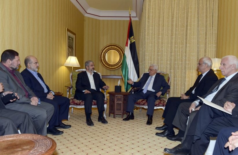 Palestinian President Mahmoud Abbas meets with Hamas leader Khaled Meshaal in Doha (photo credit: REUTERS)