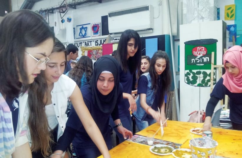 A Book Club meeting of students from the Lady Davis Multidisciplinary High School in Tel Aviv and the Multidisciplinary High School in Taiba. (photo credit: COURTESY AMAL)