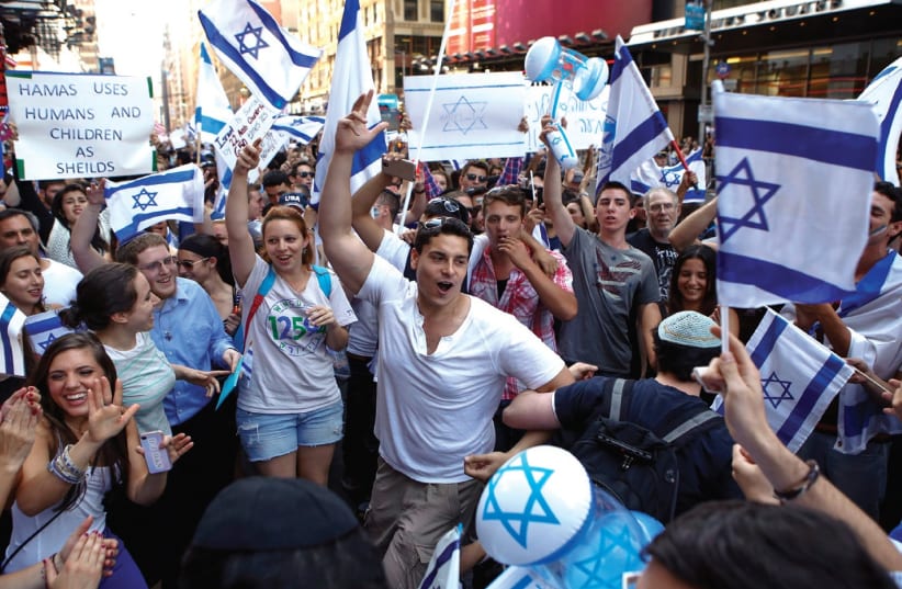 SUPPORTERS OF ISRAEL dance during a rally in New York on Sunday. (photo credit: REUTERS)