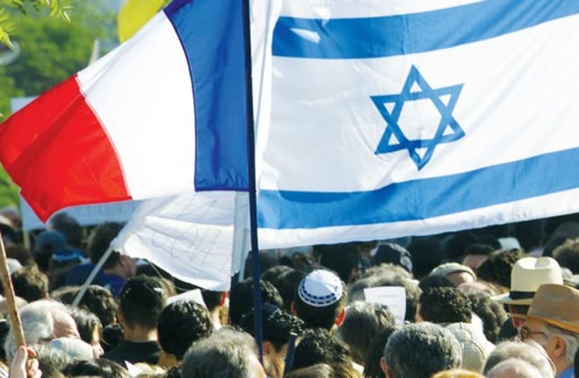 A French and Israeli flag are seen during a 2001 demonstration in Paris. (photo credit: REUTERS)