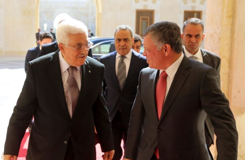 Jordan's King Abdullah (R) welcomes Palestinian President Mahmoud Abbas at the Royal Palace in Amman (photo credit: REUTERS)