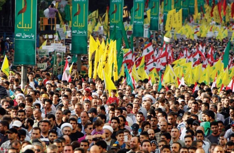 Supporters of Hezbollah head Hassan Nasrallah march at an anti-US rally in Beirut in September 2012. (photo credit: REUTERS)