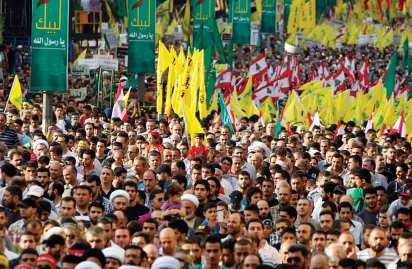 Supporters of Hezbollah head Hassan Nasrallah march at an anti-US rally in Beirut in September 2012. (photo credit: REUTERS)
