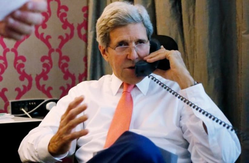 US Secretary of State John Kerry speaks on the phone to Prime Minister Binymain Netanyahu, from his hotel suite in Cairo July 25, 2014.  (photo credit: REBECCA FRIEDMAN)