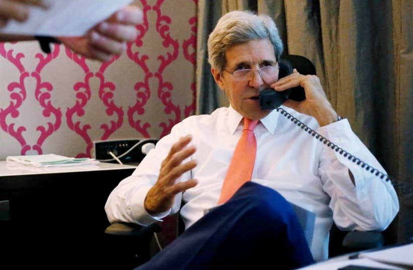 US Secretary of State John Kerry speaks on the phone to Prime Minister Binyamin Netanyahu, from his hotel suite in Cairo July 25, 2014. (photo credit: REUTERS)