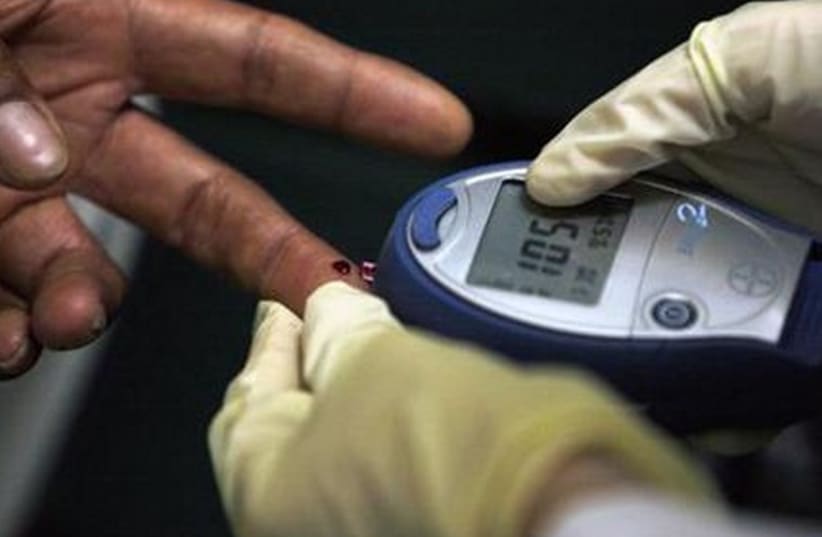 A diabetic has his blood sugar level measured in downtown. (photo credit: REUTERS)