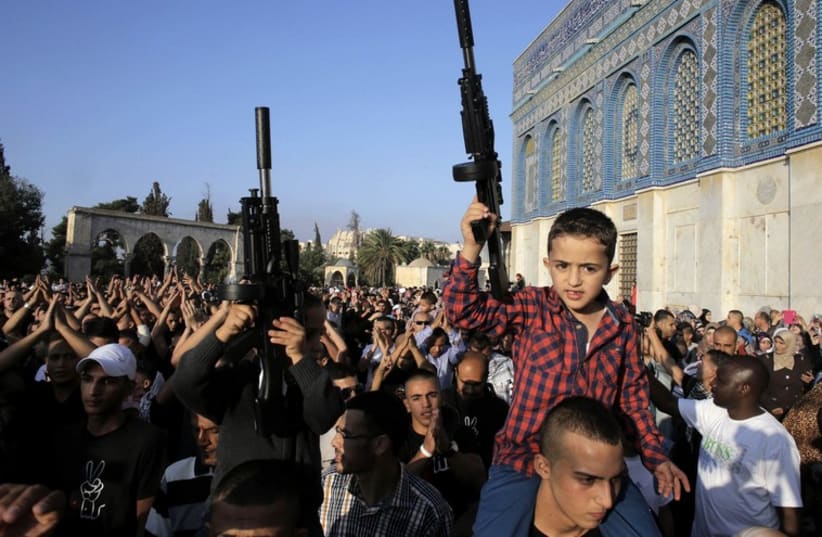 Palestinian children hold toy guns during a protest in Jerusalem (photo credit: REUTERS)