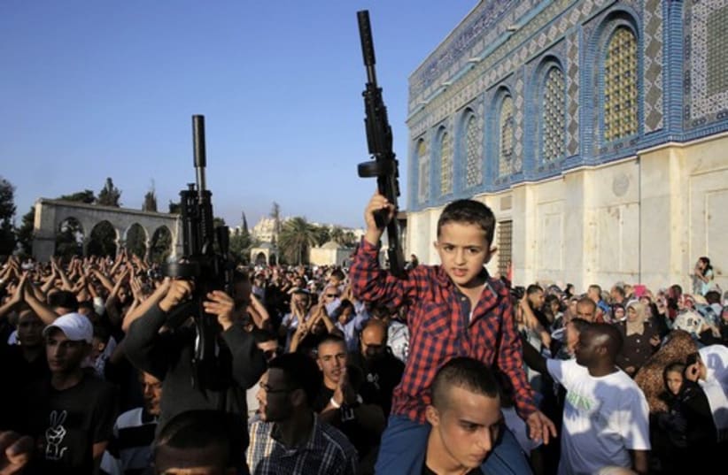 Palestinian children hold toy guns during a protest in Jerusalem (photo credit: REUTERS)
